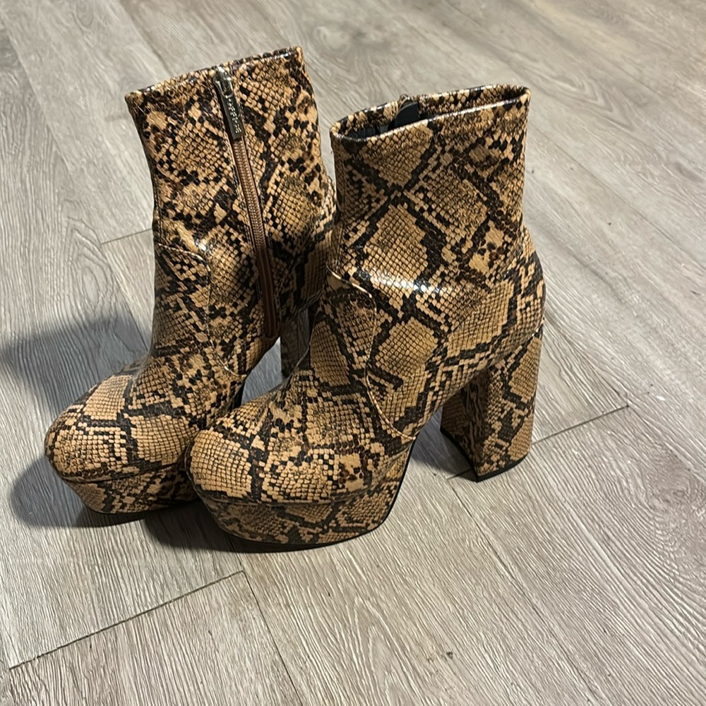 Stylish platform boots in great condition! Faux snake print.